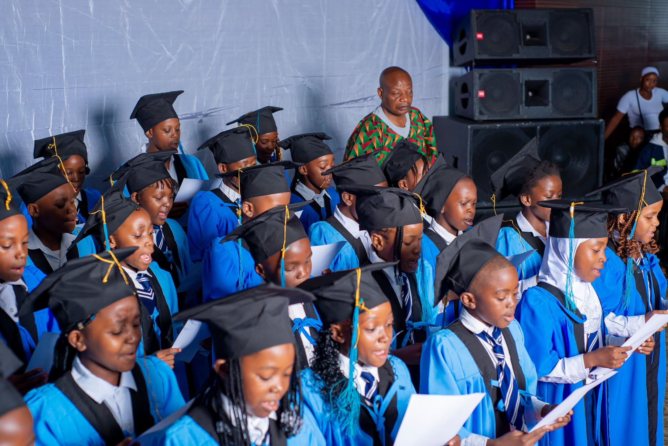 A graduate reading during the ceremony